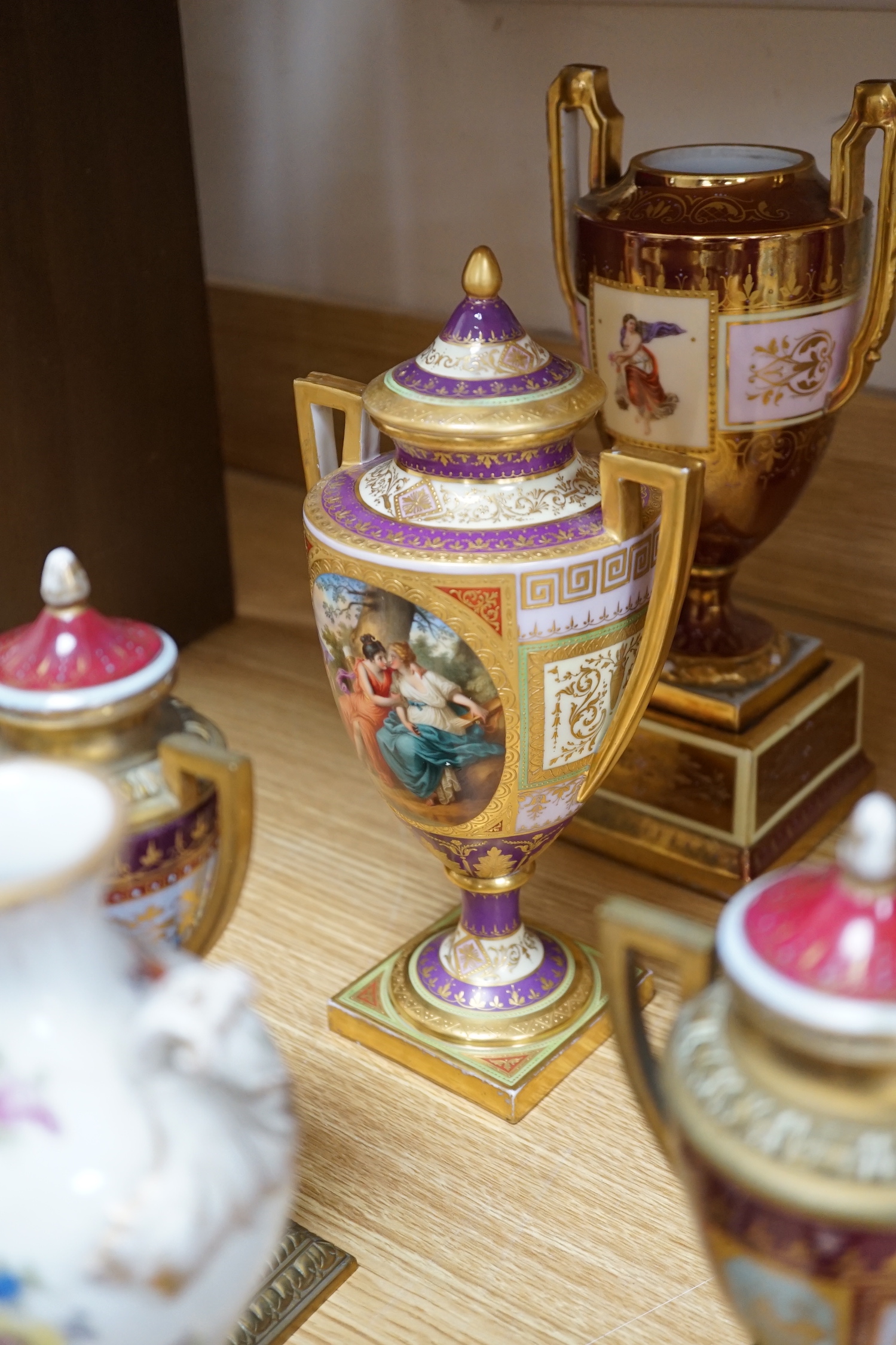 Ten Vienna type porcelain and brass pedestal vases, six with covers, largest 29cm high